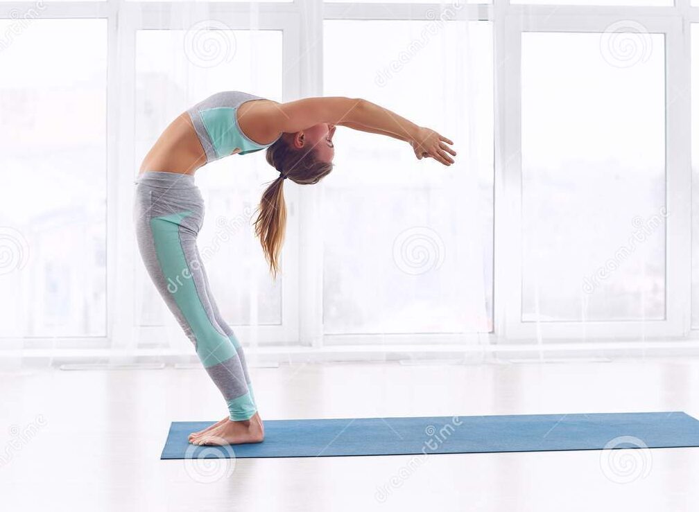 beautiful young woman practices yoga asana ardha chakrasana half wheel pose yoga class beautiful young woman practices yoga 108437998 edited